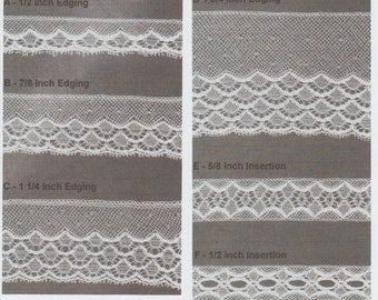 May include: A display of six different white lace trims. The trims are labeled with their widths in inches, ranging from 1/2 inch to 1 3/4 inches. The edging and insertion styles showcase various delicate patterns, suitable for sewing and craft projects.
