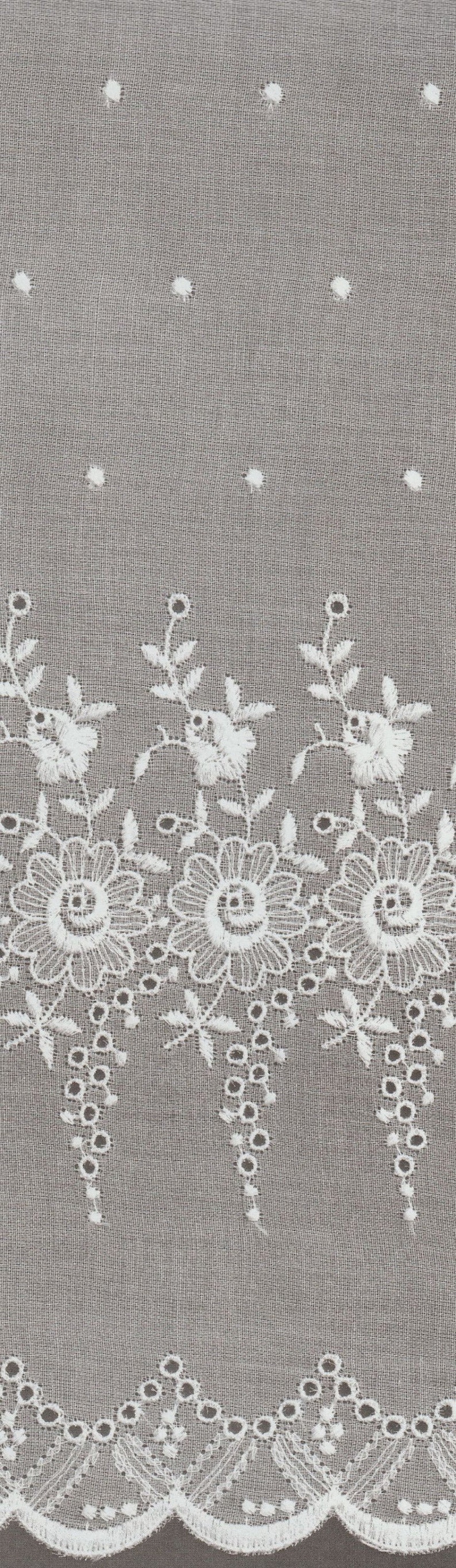 May include: White cotton fabric with a delicate embroidered floral pattern. The fabric has a scalloped edge and small holes throughout.