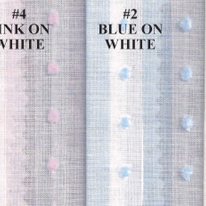 May include: Four fabric swatches with different colored polka dots on white backgrounds. The swatches are labeled with text: "#1 WHITE ON WHITE", "#4 PINK ON WHITE", "#2 BLUE ON WHITE", and "#3 YELLOW ON WHITE". The fabric has a textured appearance.