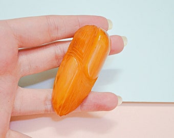 1930s Bakelite carved dress clip, 30s Catalin butterscotch fur clip, Early plastic jewellery