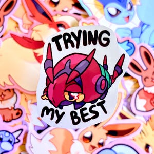 Può includere: Un adesivo con un personaggio dei cartoni animati rosso e viola e le parole "TRYING MY BEST" in nero. L'adesivo è circondato da altri adesivi di personaggi dei cartoni animati colorati.