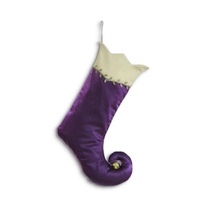 May include: Purple Christmas stocking with a gold bell and a cream coloured cuff with green embroidery.