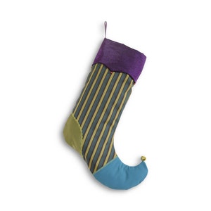 May include: A colorful Christmas stocking with a purple cuff, yellow and green striped body, and a blue toe with a gold bell.