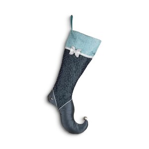 May include: A blue and silver Christmas stocking with a pointed toe and a white bow. The stocking is decorated with silver glitter.