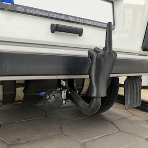 Trailer hitch cover in middle finger design