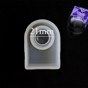 May include: A white silicone mould for making resin rings. The mould is shaped like a ring and has a 21 mm diameter opening.