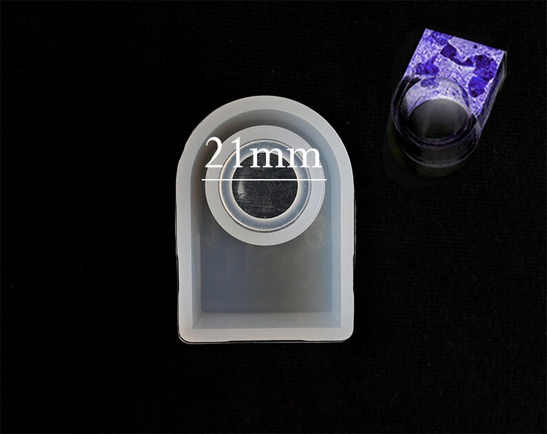 May include: A white silicone mould for making resin rings. The mould is shaped like a ring and has a 21 mm diameter opening.