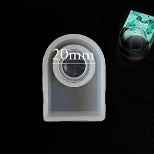 May include: A white silicone mould for making resin rings. The mould is shaped like a ring and has a 20mm diameter opening.
