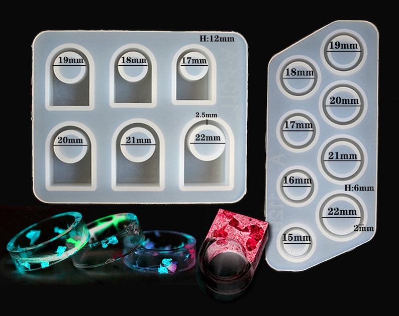 May include: Two silicone moulds for making resin rings. The mould on the left has six ring cavities in sizes 17mm, 18mm, 19mm, 20mm, 21mm, and 22mm. The mould on the right has seven ring cavities in sizes 15mm, 16mm, 17mm, 18mm, 19mm, 20mm, and 21mm. Four finished resin rings are shown in the foreground.