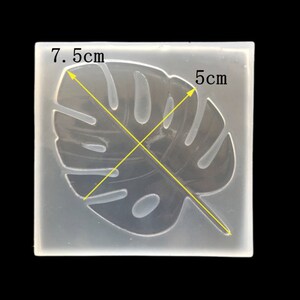 May include: Clear silicone mold for crafting, shaped like a monstera leaf. The mold measures 7.5 inches by 5 inches.