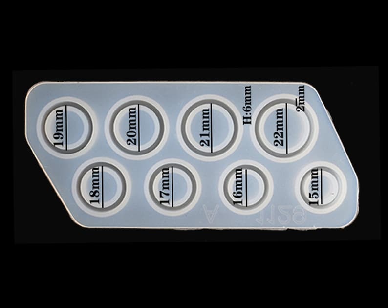 May include: Silicone mould with eight round cavities for making resin rings. The mould has measurements in millimetres for each cavity: 15mm, 16mm, 17mm, 18mm, 19mm, 20mm, 21mm, and 22mm.