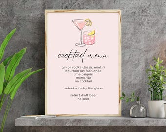 May include: A framed cocktail menu with a pale pink backdrop. The menu displays cocktail illustrations and a list of drinks, including martinis and margaritas. The text reads "cocktail menu".