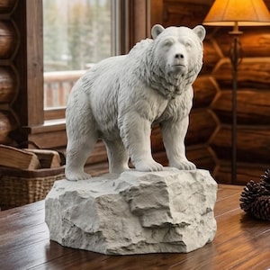May include: A white bear statue stands on a rock-like base on a wooden table. The bear is in a rustic living room with a stone fireplace, a window with a mountain view, and a cozy armchair. Decorative items include brass candlesticks and pine cones.