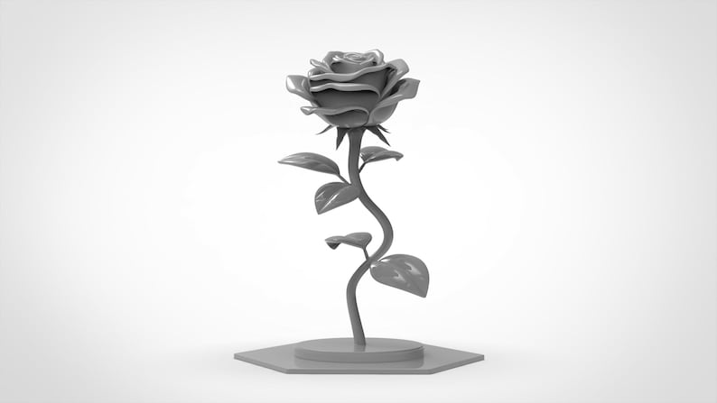 May include: A solid gray monochromatic sculpture of a single rose flower with a curved stem, several leaves, and a blooming head. The entire object is mounted on a flat, hexagonal base, presenting a uniform matte finish throughout the structure.