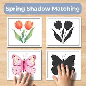 May include: A spring-themed educational game with the text "Spring Shadow Matching." The game features four square cards with illustrations of tulips and a butterfly, along with their corresponding black silhouettes. The cards are on a wooden surface.