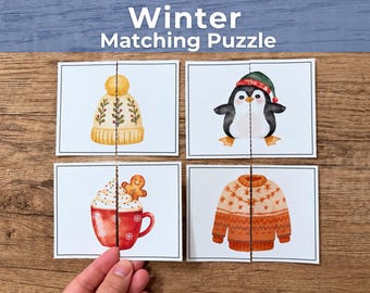 May include: A Winter Matching Puzzle set featuring four rectangular cards with illustrations of a yellow knit hat, a penguin in a green hat, a red mug with whipped cream and a gingerbread man, and an orange sweater with snowflake patterns.