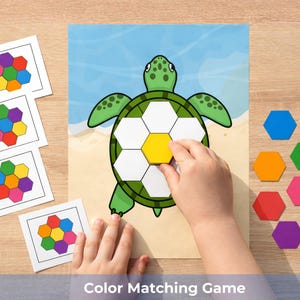 May include: A colour matching game featuring a green turtle with a segmented shell. The game includes colourful hexagonal pieces and matching cards. The text "Color Matching Game" is at the bottom of the image.