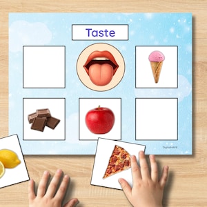 May include: A learning activity featuring a light blue background with the word "Taste" at the top. The image includes illustrations of a tongue, ice cream, chocolate, an apple, and pizza. A child's hands are interacting with the cards.