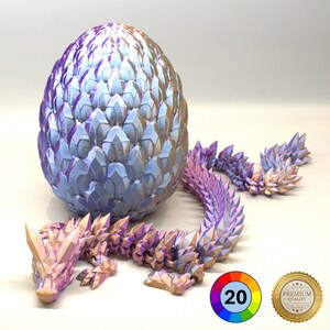 May include: A 3D-printed dragon and egg set in shades of purple, blue, and gold. The dragon has a segmented body and a detailed head. The egg is large and textured. A colour wheel and a "Premium Quality" seal are in the image.
