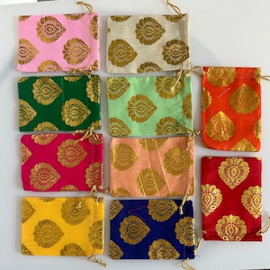 May include: A collection of small, rectangular drawstring pouches in various colors, including pink, green, orange, and blue. Each pouch features a gold paisley pattern and a gold drawstring closure. The pouches are made of a shiny fabric.