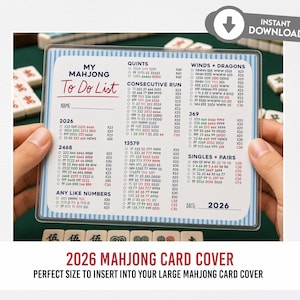 May include: A clear plastic Mahjong To Do List card with a blue and white border, held by hands. The card features lists for Quint, Consecutive Run, Winds + Dragons, 369, Singles + Pairs, and other Mahjong combinations. The text "2026" is visible.