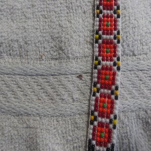 7 bead Friendship bracelet with orange and red rosettes