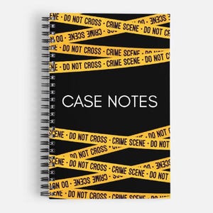 May include: Spiral-bound notebook with a black cover featuring the words "CASE NOTES" in white. The cover is decorated with yellow "CRIME SCENE DO NOT CROSS" tape. The notebook is designed for taking notes.
