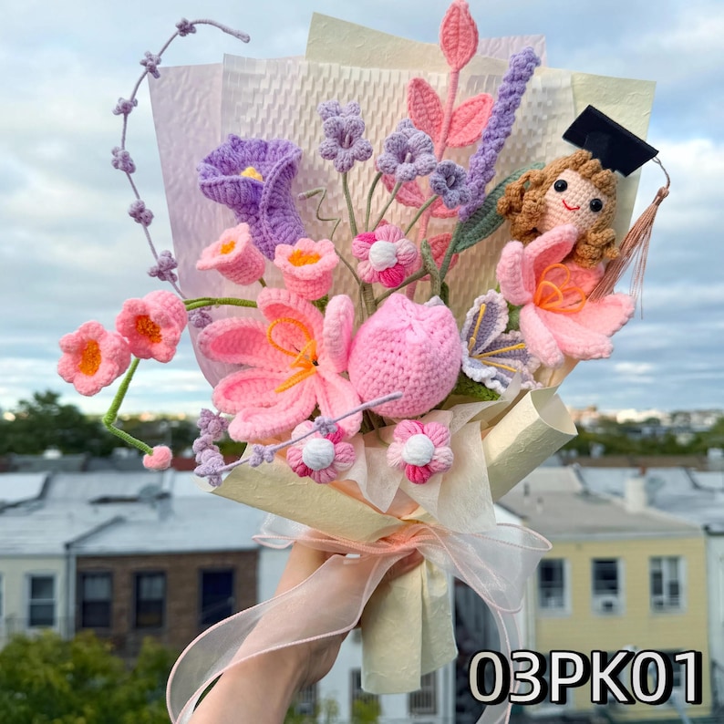 Crochet graduation bouquet in pink and lilac hues with crochet tulips and roses, soft pastel wrapping.