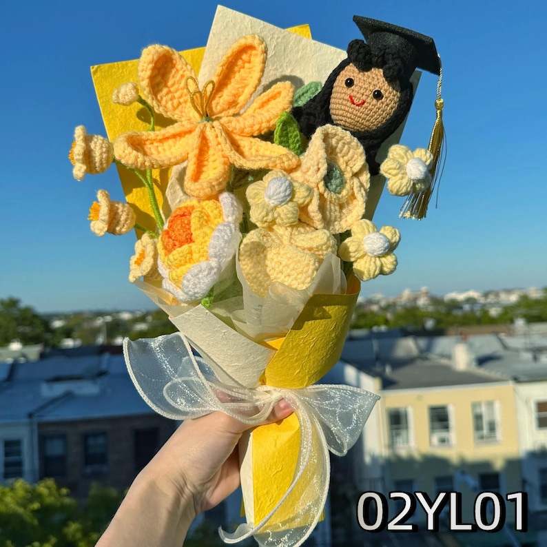 Crochet graduation bouquet in soft yellow tones with crochet lilies and small white flowers.