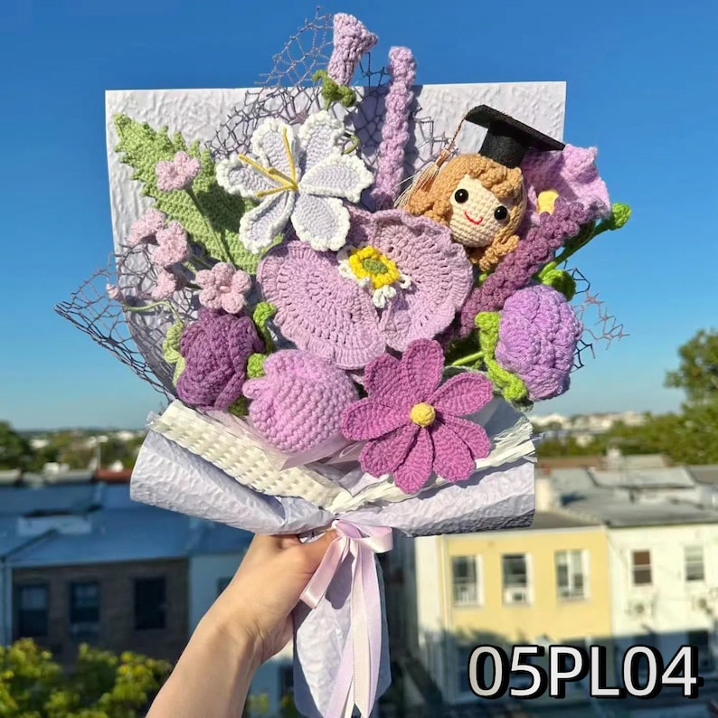 Crochet graduation bouquet in purple and white palette with crochet daisies and lilac blossoms.