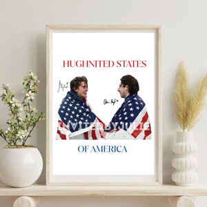 May include: Framed print featuring two people holding an American flag, with the text "HUGHNITED STATES OF AMERICA" in red. The print includes signatures and is displayed on a white shelf with decorative elements.