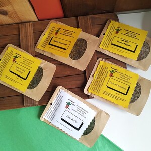 May include: Five brown paper bags with yellow labels containing different types of dried herbs and spices. The labels have the name of the blend, "Backyard Patch Herbs", and a website address. The blends are "Soup & Salad Seasoning", "Italian Seasoning", "No Salt Lemon Pepper", "Do-It-All Seasoning", and "Fine Herbs".