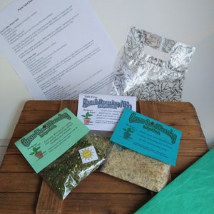 May include: Three small bags of dried salad dressing mix. The bags are labeled "Green Chili Dressing", "Salt-Free Ranch Dressing/Dip", and "Caesar Salad Dressing". Each bag has a small illustration of a plant.