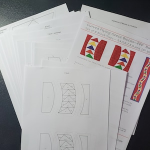 May include: A set of 8 printable patterns for curved flying geese quilt blocks. The patterns are for blocks ranging in size from 3 to 10 inches. The patterns are printed on white paper.