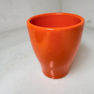 May include: A set of three ceramic mugs with a speckled, matte finish. The mugs are in shades of cream, light gray, and dark gray. Each mug has a simple, modern design and a rounded handle.