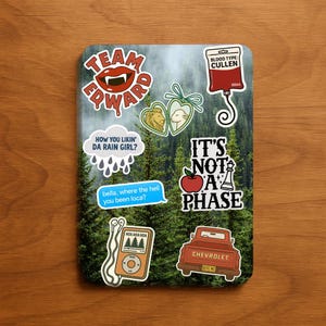 May include: A rectangular sticker sheet featuring various pop culture-themed stickers. Designs include text like "Team Edward," "Blood Type: Cullen," and "It's Not a Phase." Other stickers depict an apple, a truck, and a music player.