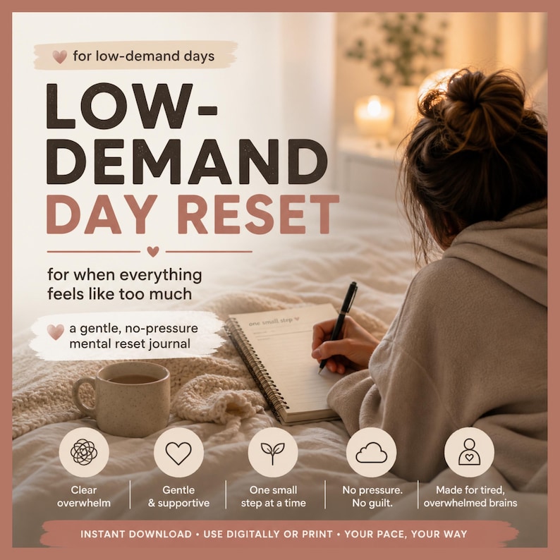 A person in bed writes in a journal titled "LOW-DEMAND DAY RESET" next to a mug, with text overlays about low-demand days.