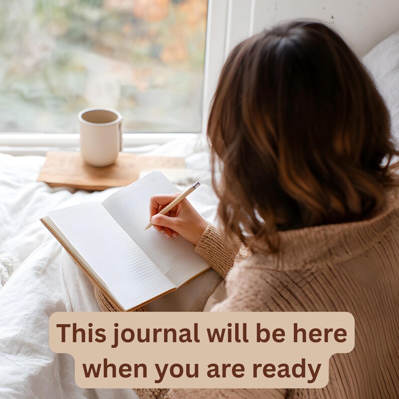 A person writes in an open journal with a pencil, sitting by a window, with text overlay: "This journal will be here when you are ready."