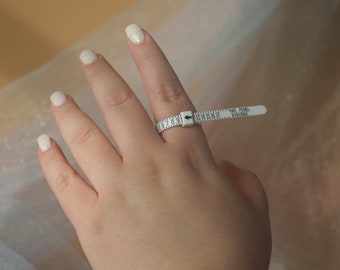May include: A white plastic ring sizer with black markings and the text "PAT. PEND. 31014603".