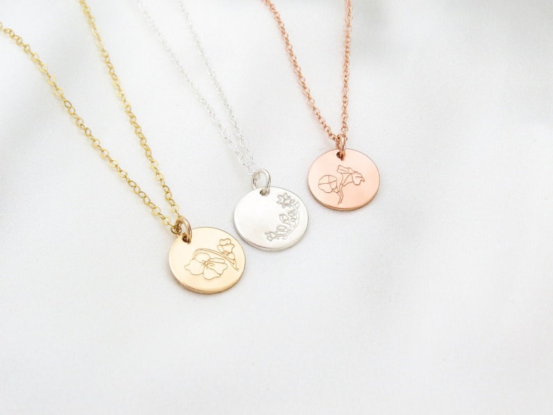 May include: Three delicate necklaces with a floral design pendant. The necklaces are available in gold, silver, and rose gold.