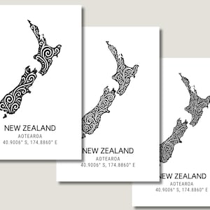 May include: Three white art prints featuring a black, stylized map of New Zealand with intricate swirl patterns. Each print includes the text "NEW ZEALAND AOTEAROA 40.9006° S, 174.8860° E" in a simple, modern font.