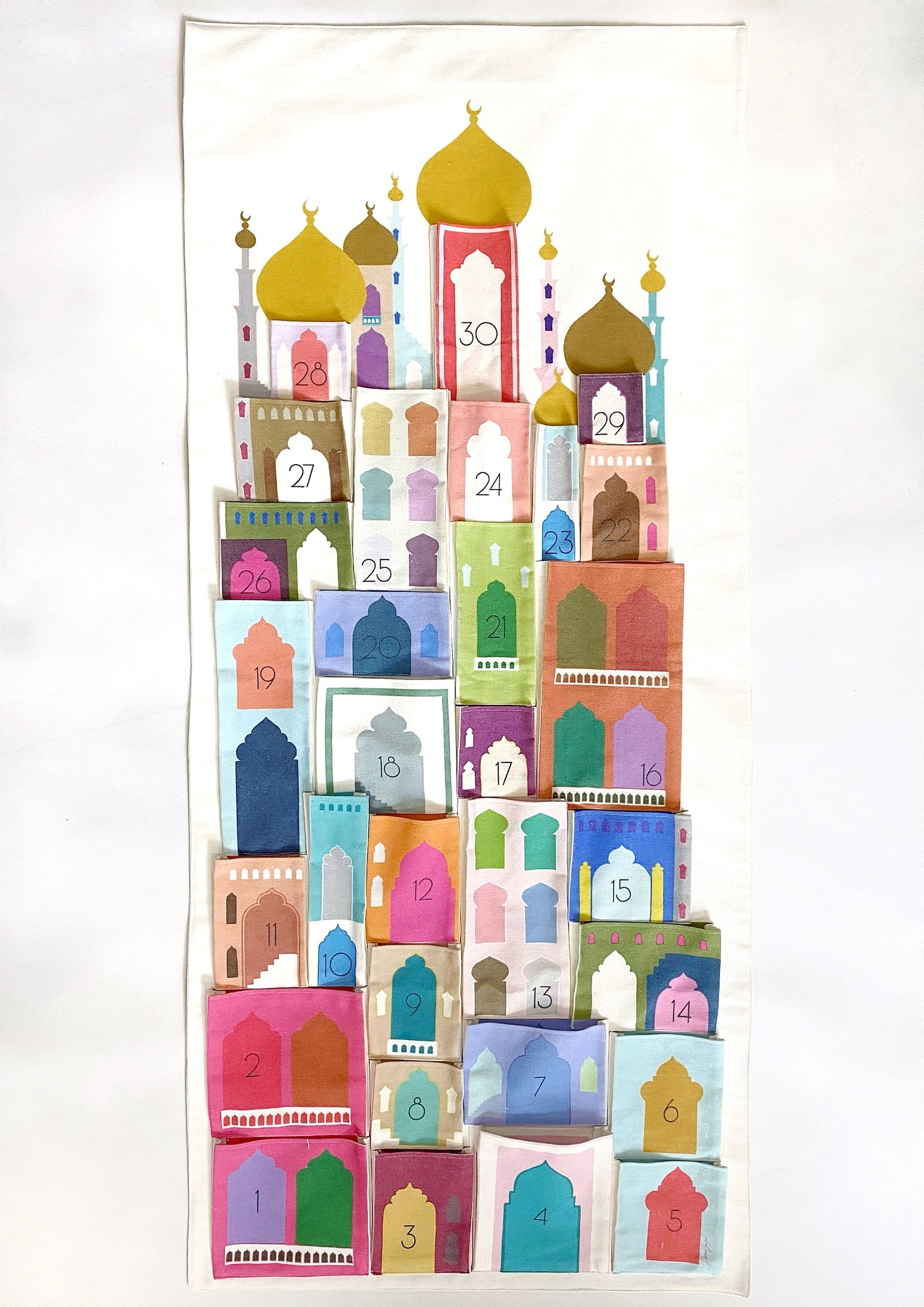 A colorful pocket calendar for Ramadan featuring mosques and buildings