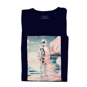 May include: Navy blue t-shirt featuring a graphic of a futuristic astronaut with the word "OMPHALI" above the astronaut. The astronaut is wearing a silver spacesuit, standing in a surreal landscape with clocks and clouds.