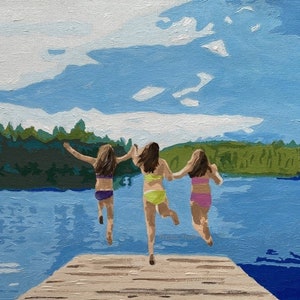 May include: Three people in swimsuits jump off a wooden dock into a lake. The lake is blue and the sky is a light blue with white clouds. The trees in the background are green.