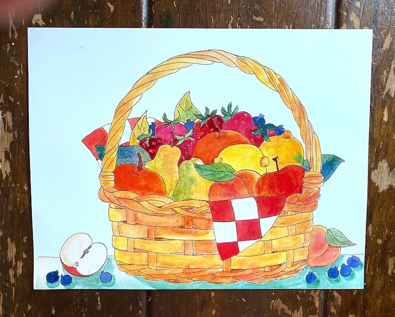 May include: A wicker basket overflowing with a variety of fresh fruit, including apples, pears, peaches, lemons, and strawberries. The basket is decorated with a red and white checkered cloth.