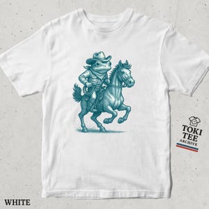 Grappige cowboy-kikker T-shirt berijden van een paard / eigenzinnige westerse dieren grafisch T-shirt / uniek amfibie-rodeoshirt voor kikkerliefhebbers en fans