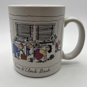 May include: White ceramic mug with a cartoon illustration of office workers in a rush. The mug features the phrase "Five O'Clock Dash" in black script. The cartoon depicts people scrambling around desks.