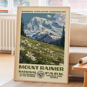 May include: A vertical poster featuring a landscape illustration of Mount Rainier with a snow-capped peak, green meadows, and wildflowers. The text reads: WASHINGTON 46.85 N, 121.75 W ESTABLISHED 1899 MOUNT RAINIER NATIONAL PARK U.S DEPARTMENT OF THE INTERIOR.