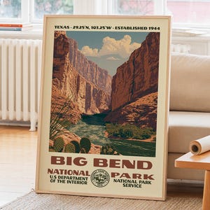 May include: A framed poster of Big Bend National Park featuring a canyon landscape with a river, cacti, and clouds. Text reads: TEXAS 29.25 N, 103.25 W, ESTABLISHED 1944, BIG BEND NATIONAL PARK, U.S. DEPARTMENT OF THE INTERIOR, NATIONAL PARK SERVICE.