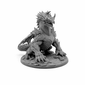 May include: A grey dragon figurine with detailed scales, horns, and wings. The dragon is in a crouching position on a circular base, showcasing a fantasy creature design. The figurine is made of a solid material.